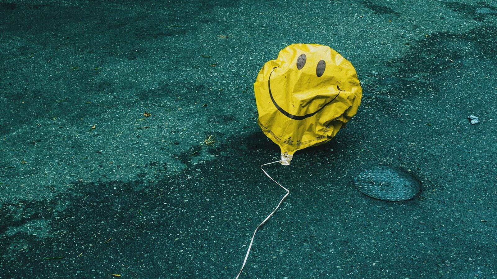 a helium balloon that's lost air sags on the ground