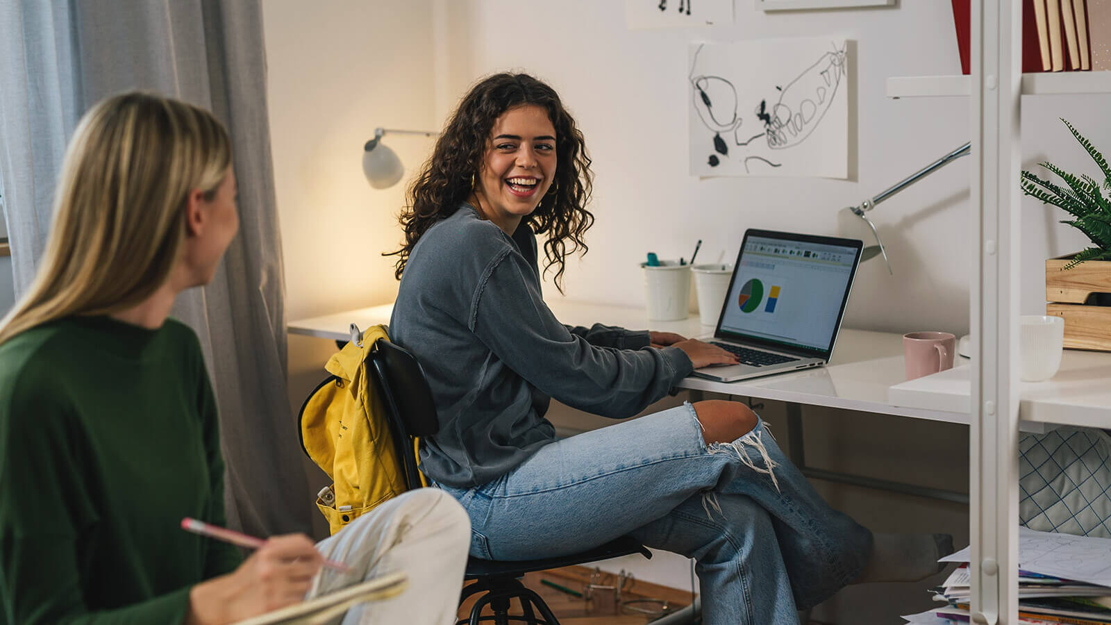 two roommates study in their dorm and talk about classes