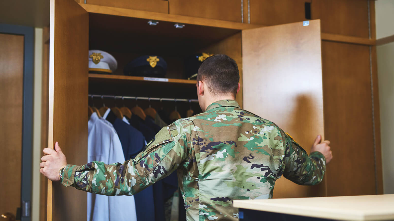 a male student opens the door of a wardrobe