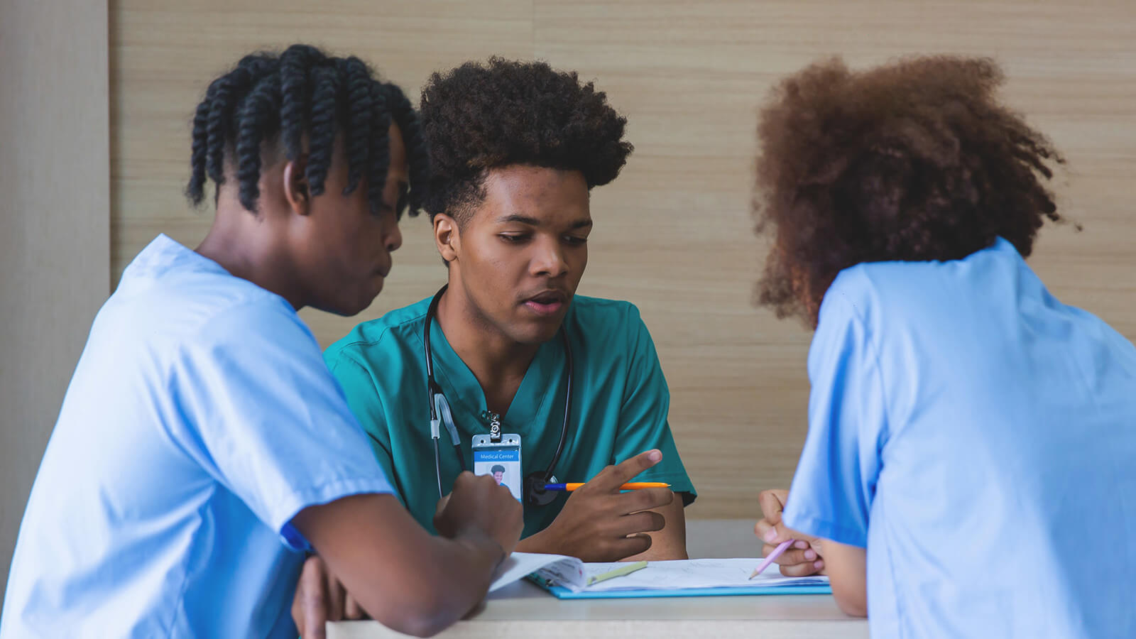 a group of students in scrubs study nursing at an HBCU
