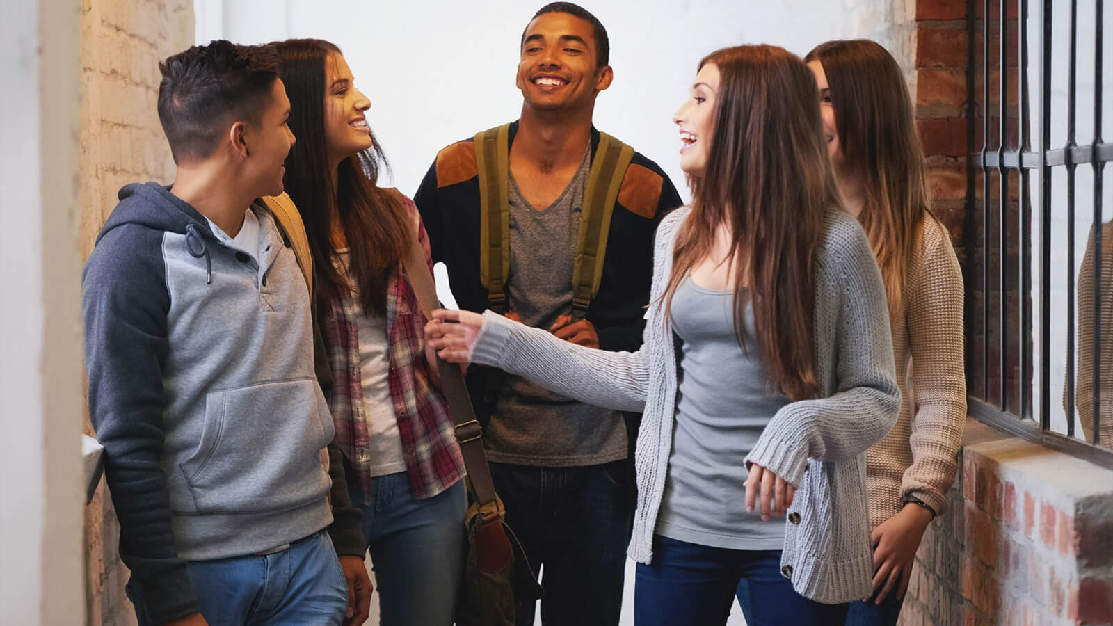 a group of college students dressed causally walk out of a classroom