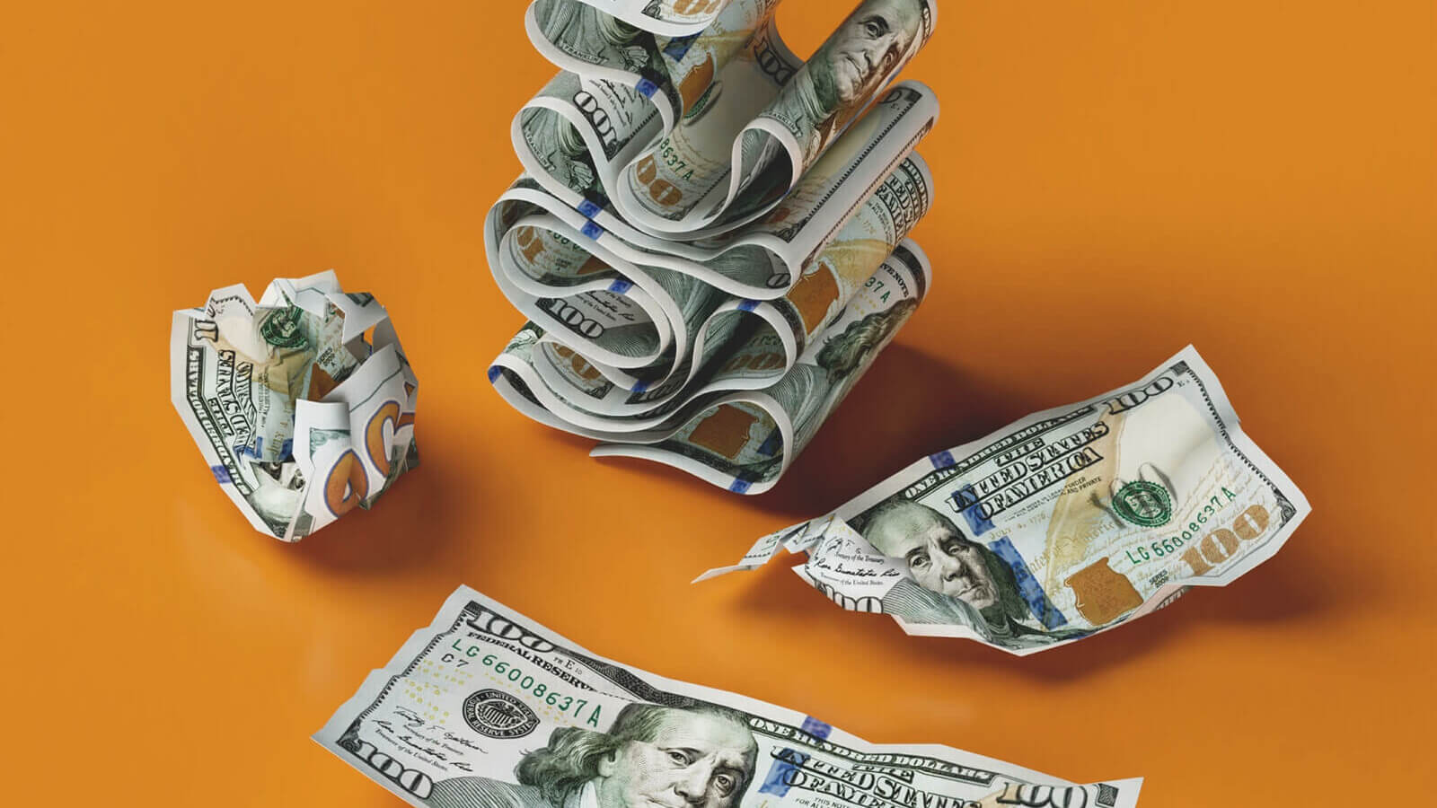 dollar bills stacked and crumpled on an orange background