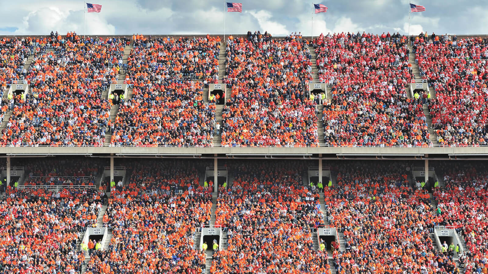 a stadium full of football fans wearing orange