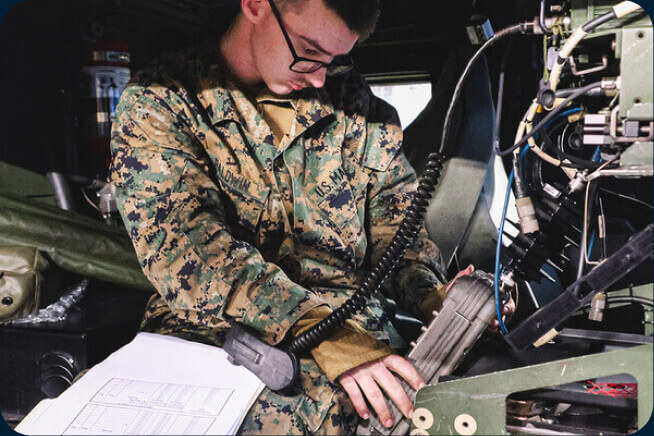A Marine works on a navigation system