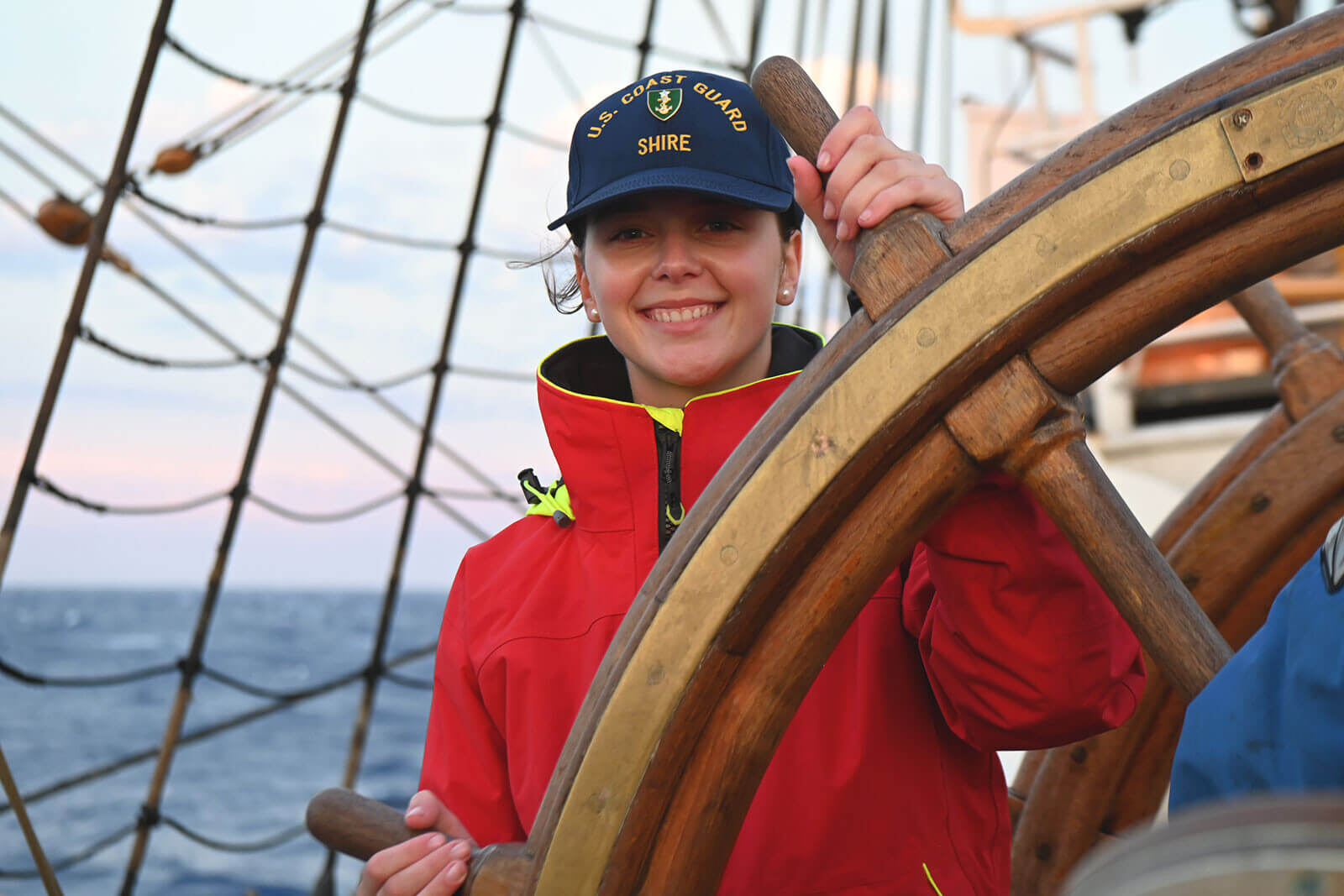 A member of the US Coast Guard steers a boat