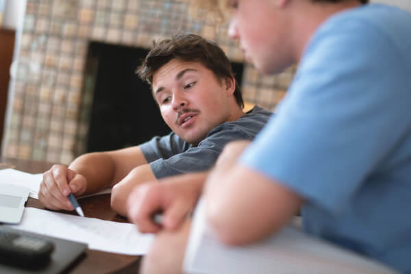 Two students looking at their AP course notes