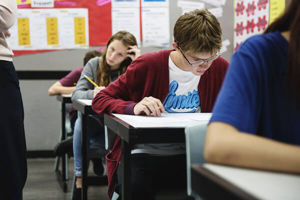 students focused on exam in high school classroom
