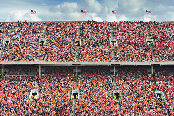 a football stadium packed with people wearing orange 