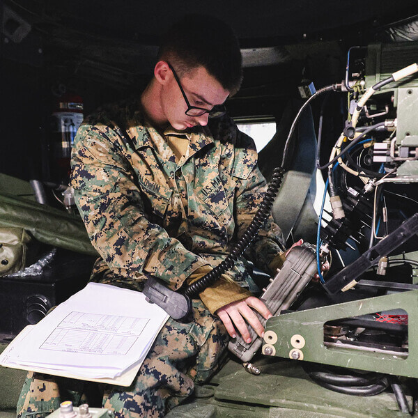 A Marine works on a navigation system