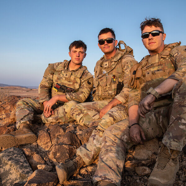 A group of guardsmen sit on a rock